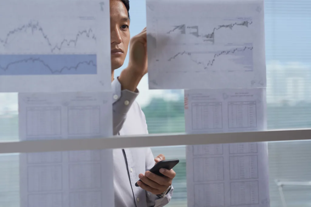 Analyst reviewing share registry charts—data oversight for HKEX-listed company compliance.